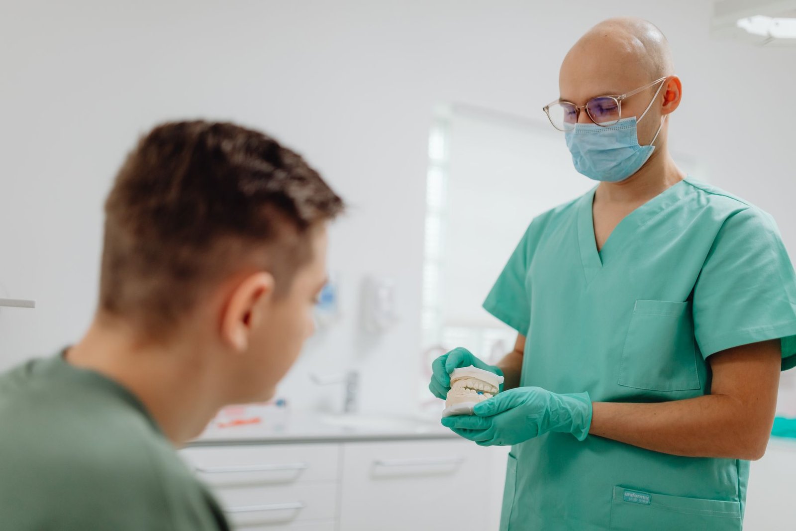 Dentist explaining care to a patient